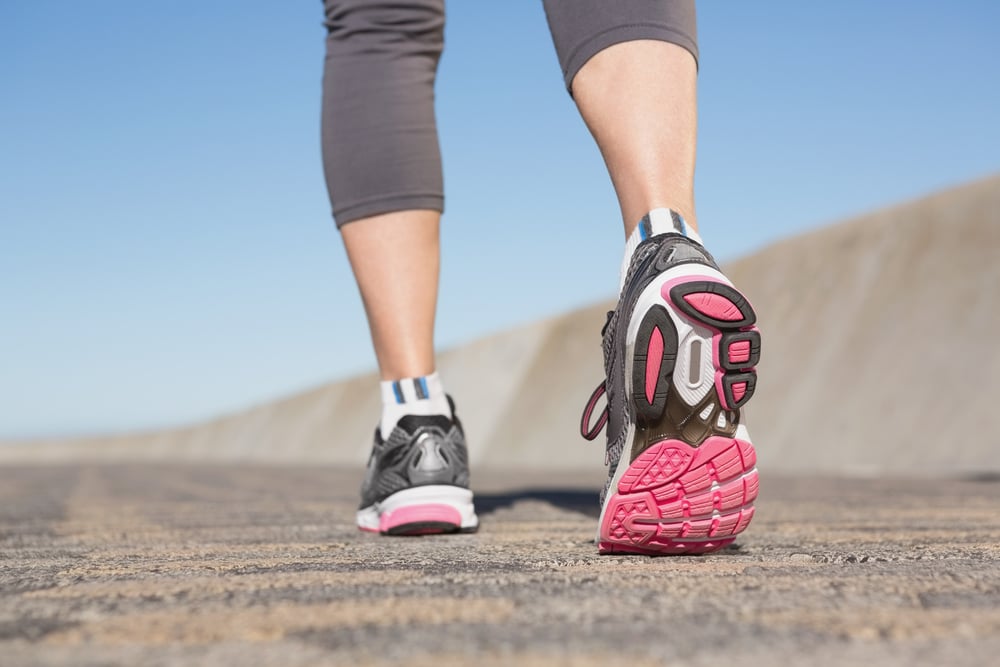 Active senior woman jogging on the pier on a sunny day