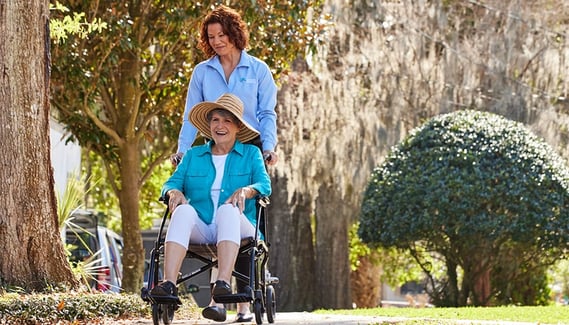 Caregiver and Senior walking on a beautiful day