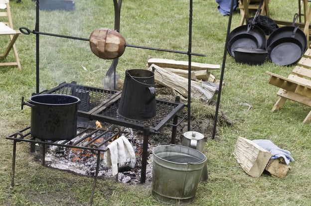 Meat (minus a few slices) roasting on spit over campfire in Confederate camp at a reenactment of the American Civil War (1861-1865)