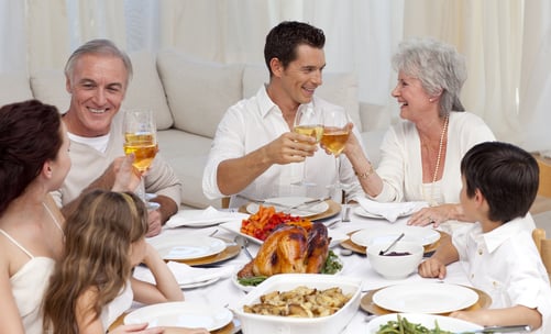 Parents and grandparents tusting with wine in a family dinner