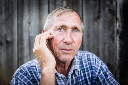 Desperate senior man suffering and covering face with hands in deep depression, pain, emotional disorder, grief and desperation concept