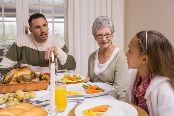 Extended family at the christmas dinner table at home in the living room